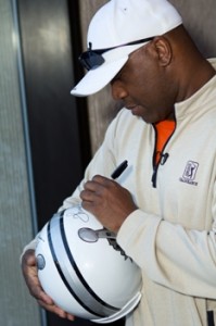 2012 Celebrity Guest Thurman Thomas Autographing a Super Bowl XLVI Helmet 